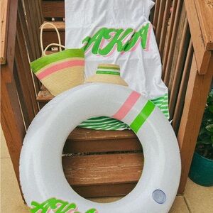 Alpha Kappa Alpha beach float, raffia tote bag, visor, and beach towel